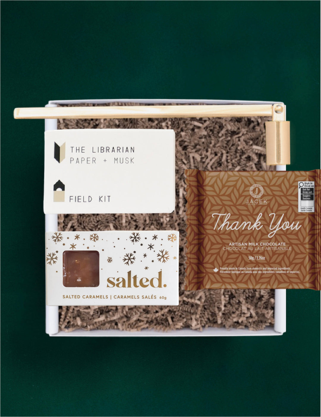 Thank You gift selection with a JACEK Thank You bar, Salted caramels, a Field Kit candle and gold candle snuffer.