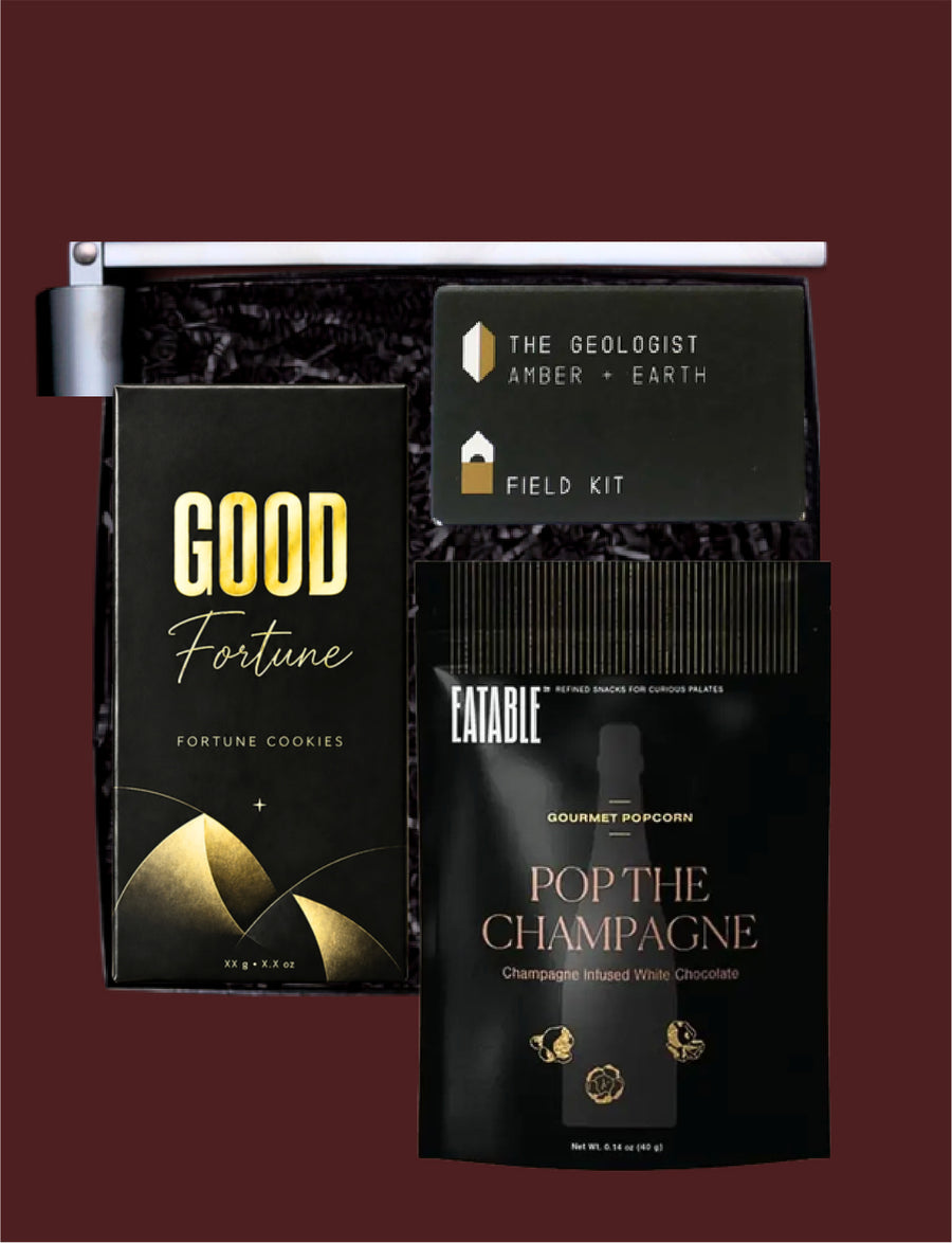 Black Tie gift selection with fortune cookies, Eatable popcorn, a Field Kit candle and a black candle snuffer.