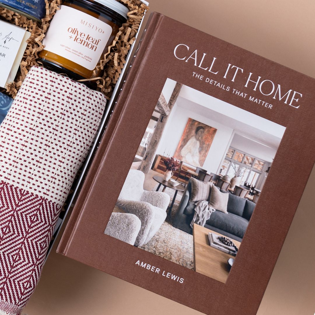 Amber Lewis's Call It Home design book beside a woven Pokoloko towel in a gift box.