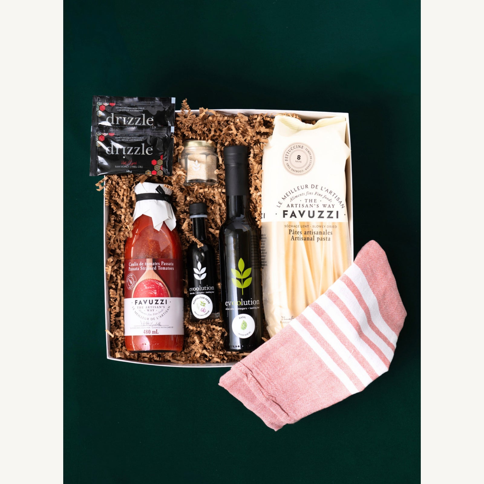 Tuscan Table gift selection with Favuzzi pasta and sauce, Drizzle hot honey, Evoolution oils, garlic sea salt and a Pokoloko towel.