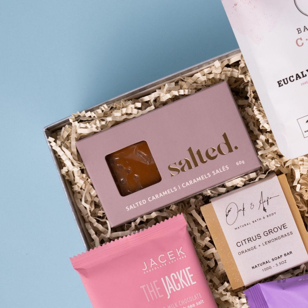 Salted caramels beside Bathorium Eucalyptus Apothecary bath soak and Oak & Aspen soap.